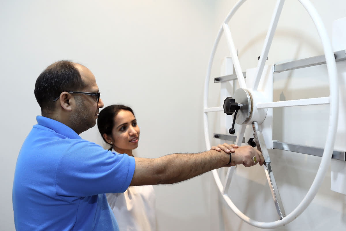 Professional physiotherapist performing manual therapy and joint mobilization techniques on patient's spine at Healers Clinic Dubai - Evidence-based hands-on treatment for musculoskeletal conditions